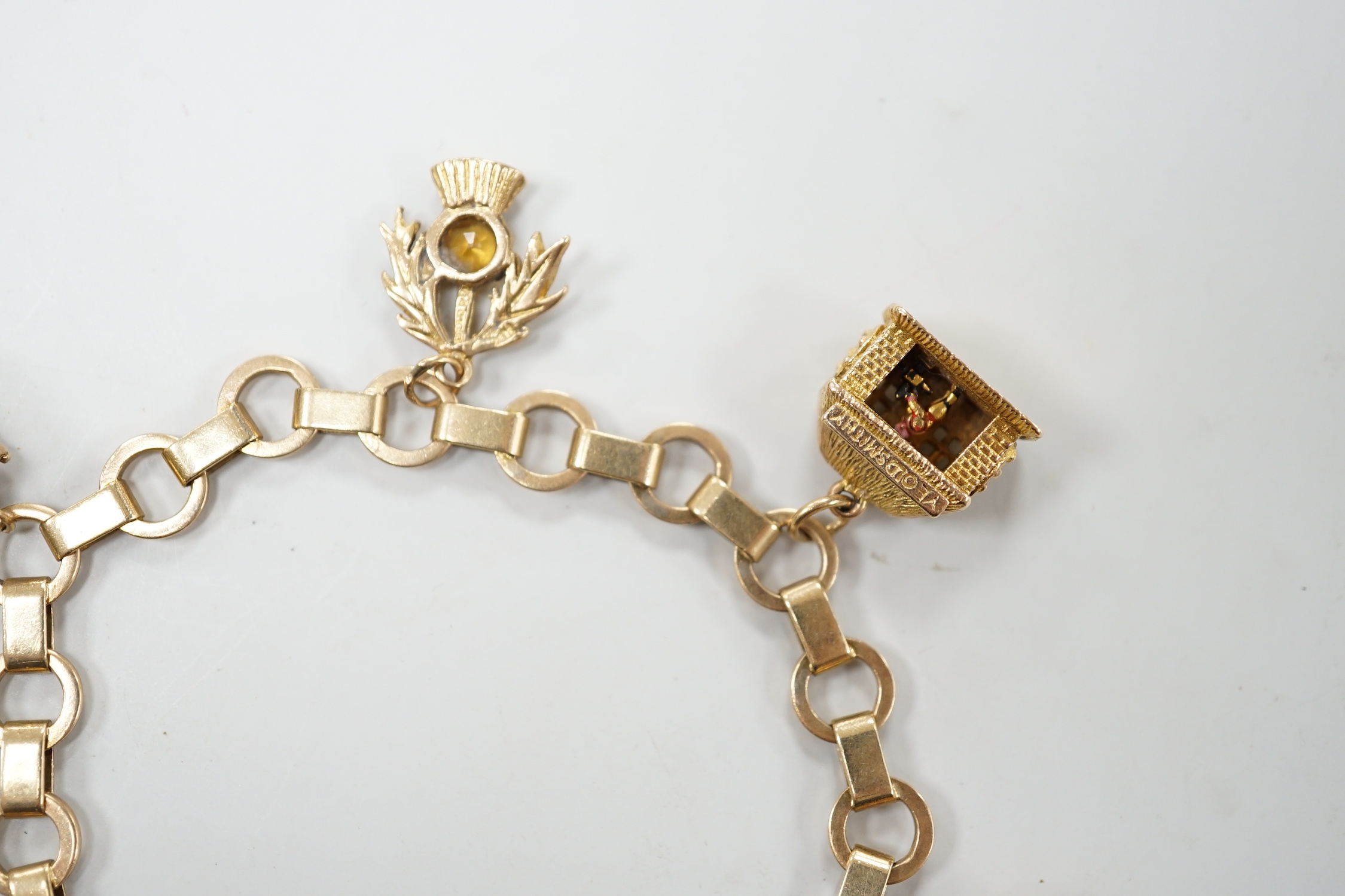 A 1950's 9ct gold charm bracelet hung with six assorted charms, gross weight 25.5 grams.
